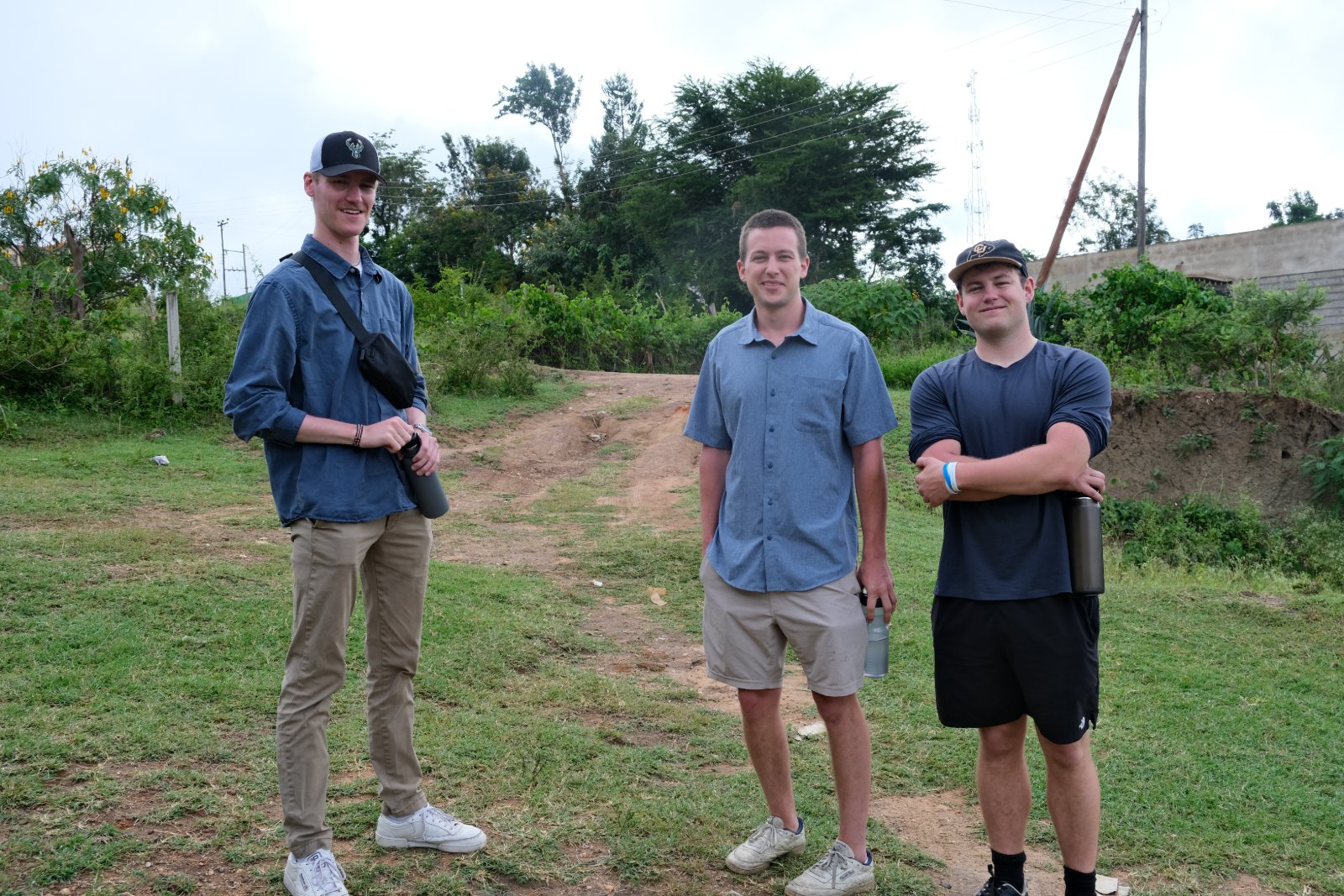 UVA interns Samuel, Jake, and Camper on a dirt path in Wamunyu during the site visit.
